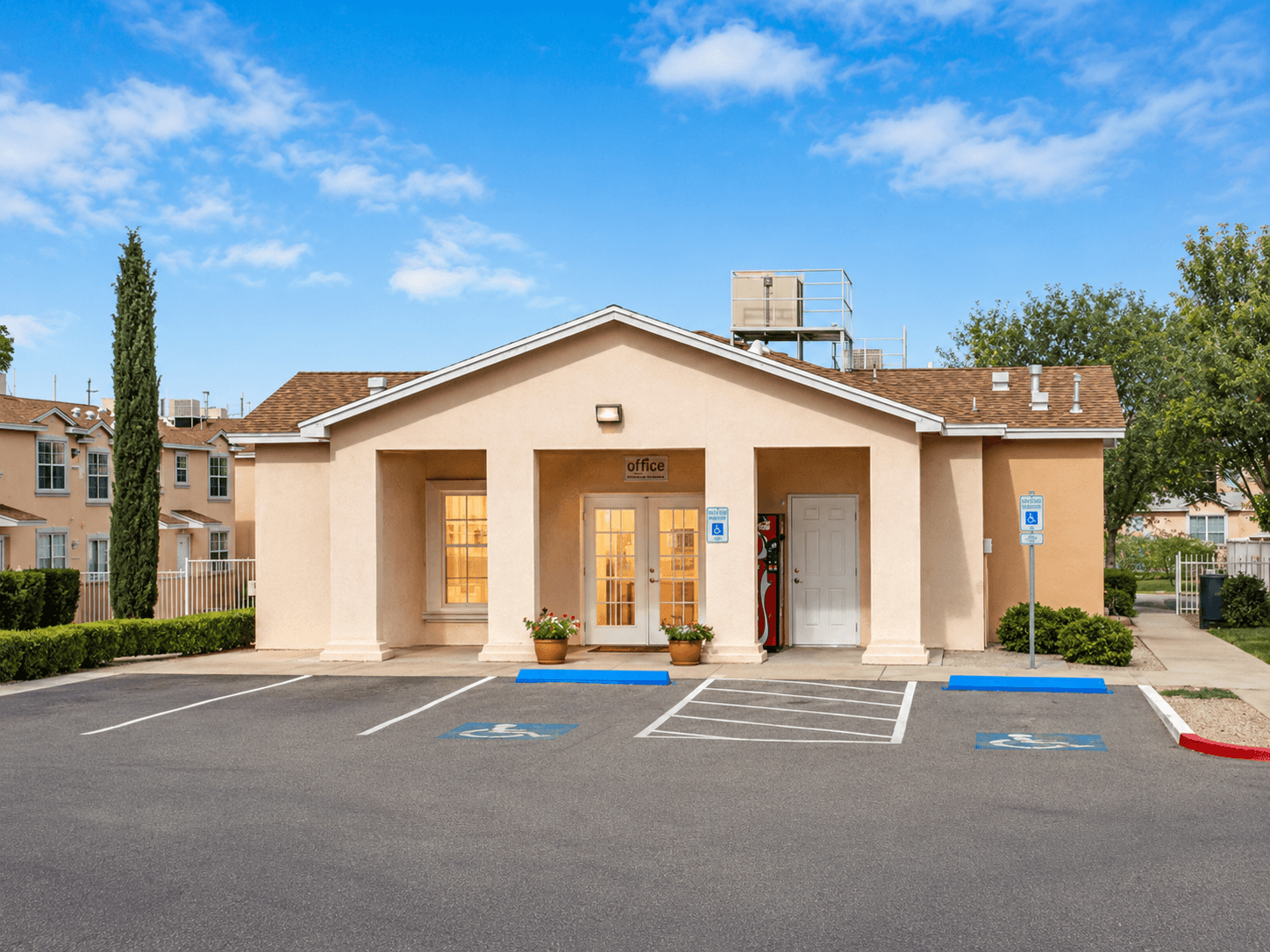 A building with a parking lot in front of it.